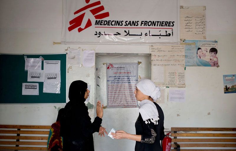 MSF medical Doctors, Nora Echaibi and MD Kalyanasundari Gomathinayagam speak together near the entrance of Al Salam Hospital on July 22, 2015 in Qataba, Yemen.
