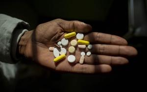 Simphiwe holds his medication, he takes up to 26 pills a day to treat XDR-TB. Here he holds his morning selection, which includes delamanid, one of the newest DR-TB drugs, which Simphiwe is taking for the first time today.