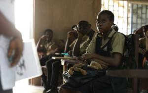 Health workers addressing school children about mental health in Liberia