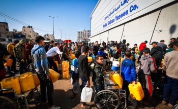 Palestinian residents queue for water in Gaza