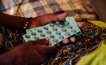 Ether, an advanced HIV patient, with her medication in her hands, in a female ward at Nsanje District Hospital, Malawi. 