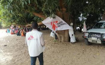 Image showing a mobile clinic under a mango tree in Kreneik town, Sudan. 