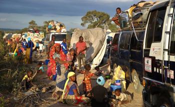 People displaced by the conflict in Cabo Delgado, a northern province in Mozambique, wait next to a truck on the outskirts of Mueda. They had previously been resettled in other areas of the province but are now aiming to reach Palma, a coastal town that was attacked earlier this year and where some people have already gradually returned. 