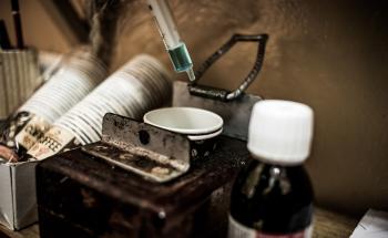 Detail of the methadone syrup and single-use cups with which beneficiaries of the heroin substitution programme take their dosage. The dosage is set by a doctor at the Alto-Mae health centre.