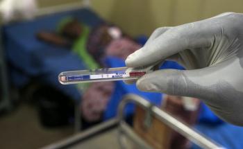 A gloved medical staff member looks at the results of a test. Antibiotic resistance is on the increase.