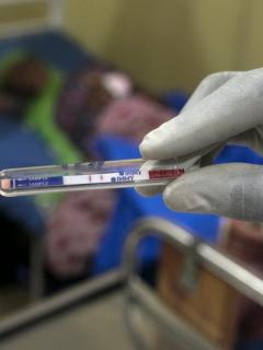 A gloved medical staff member looks at the results of a test. Antibiotic resistance is on the increase.