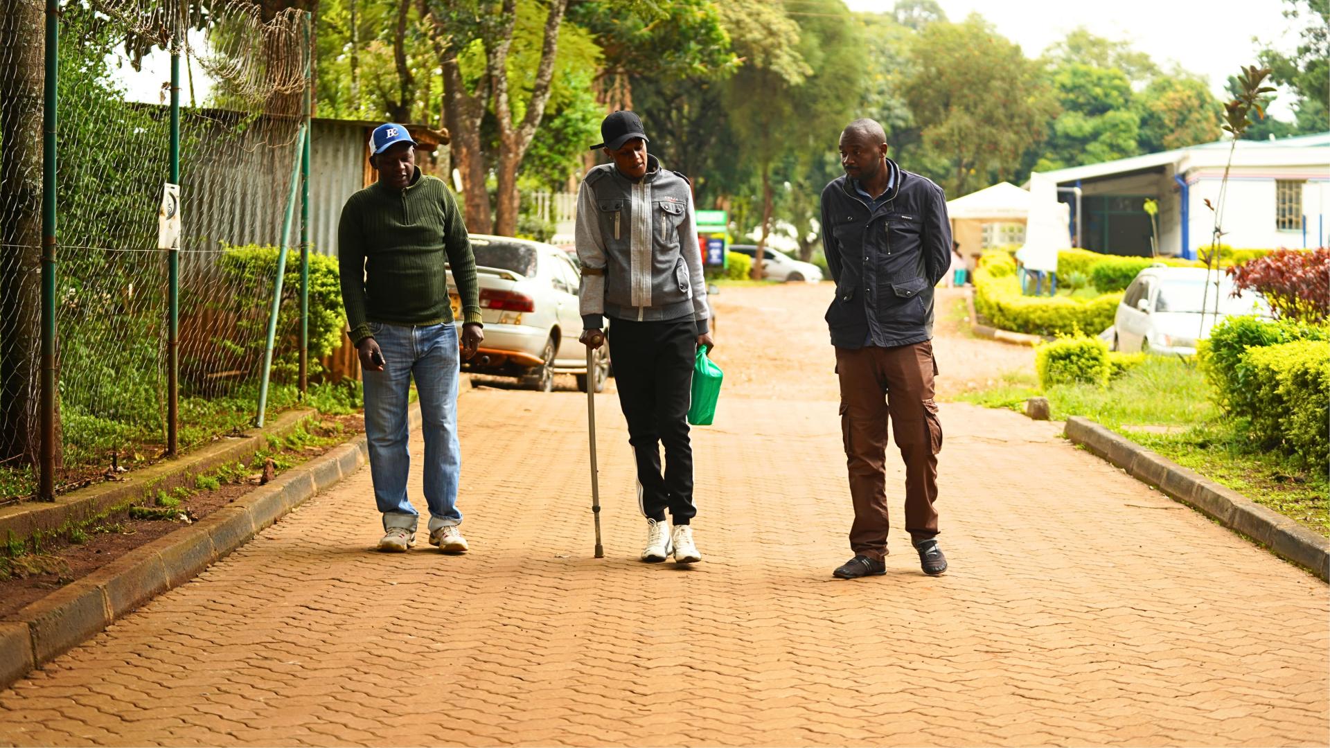 Treatment of People Who Use Drugs in Kenya: Mburu Michael is flanked by his father (left) and uncle (right) as they arrive at the Karuri medically assisted therapy clinic in Karuri for his take home methadone dose.