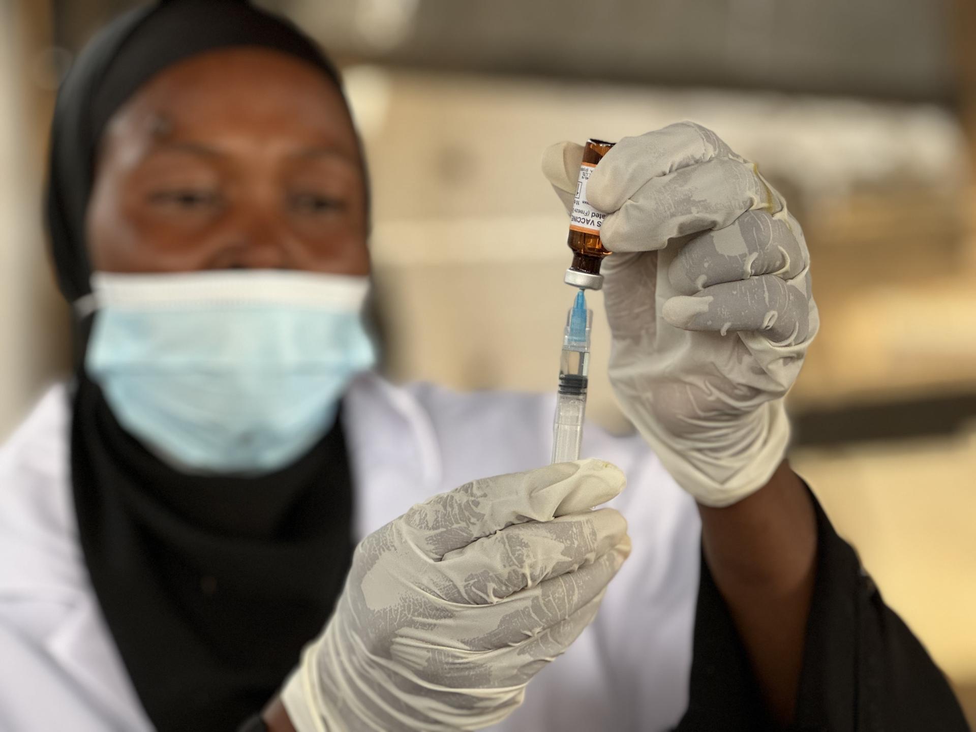 Life-saving care in Sudan: Adré, eastern Chad. A girl is getting vaccinated against measles by an MSF staff as part of a vaccination campaign carried-out by MSF in Adré transit camp.