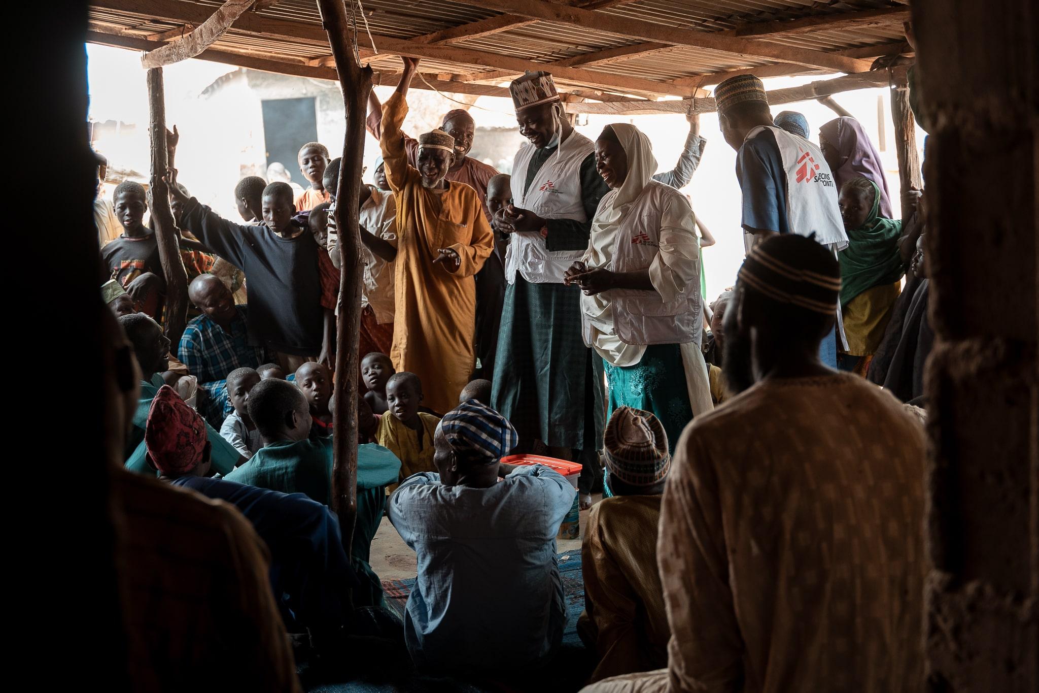 Acute Malnutrition in Nigeria: Maryam Muhammad and the MSF health promotion team conduct a Tom Brown sensitization session for men in Kebbi. Convincing men to support the approach is key as the mostly are the one supplying the family. For cultural reasons, MSF organizes separated sessions for men and women.