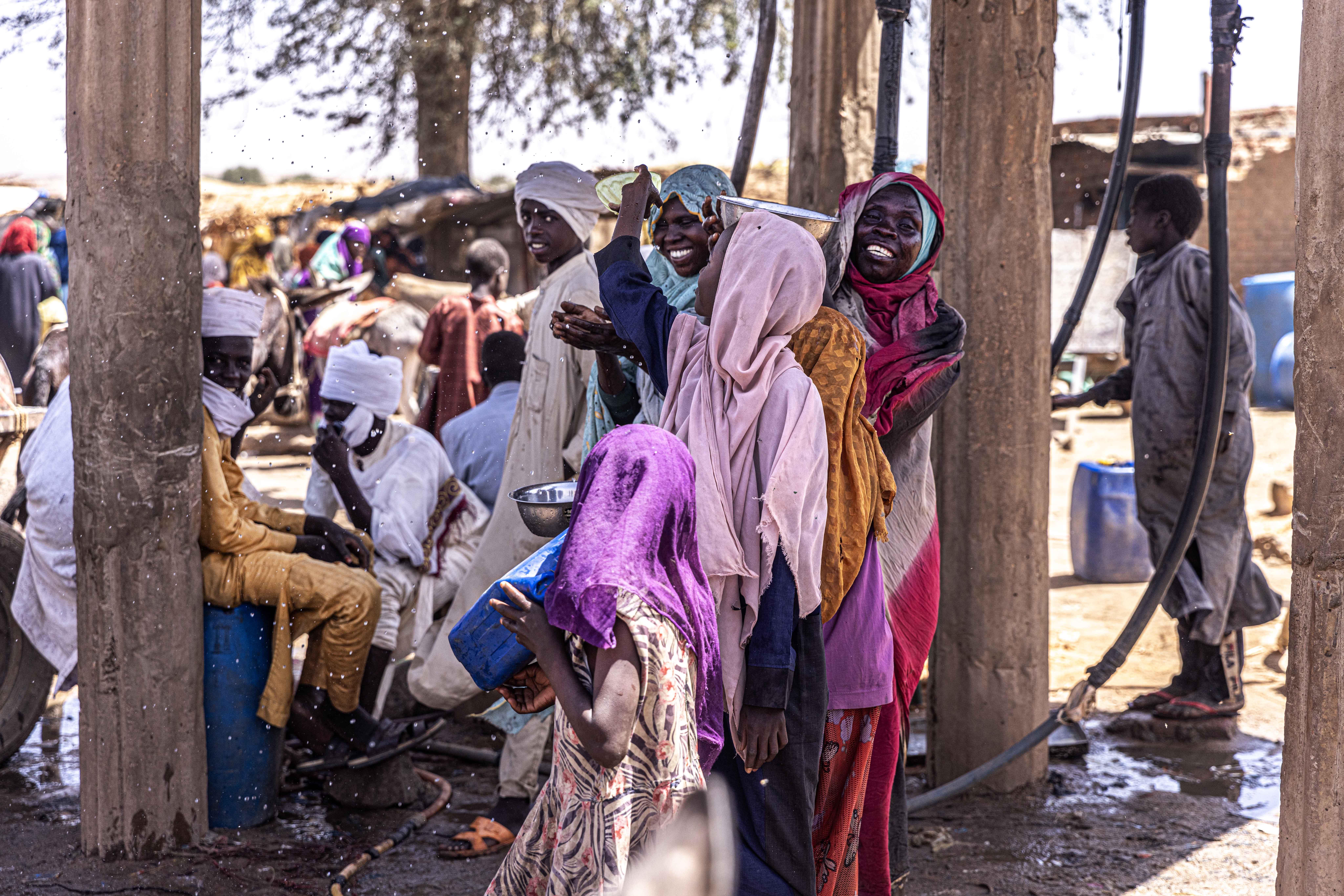 Adre, Chad:  Women collecting water at the Adré transit camp distribution point, eastern Chad.