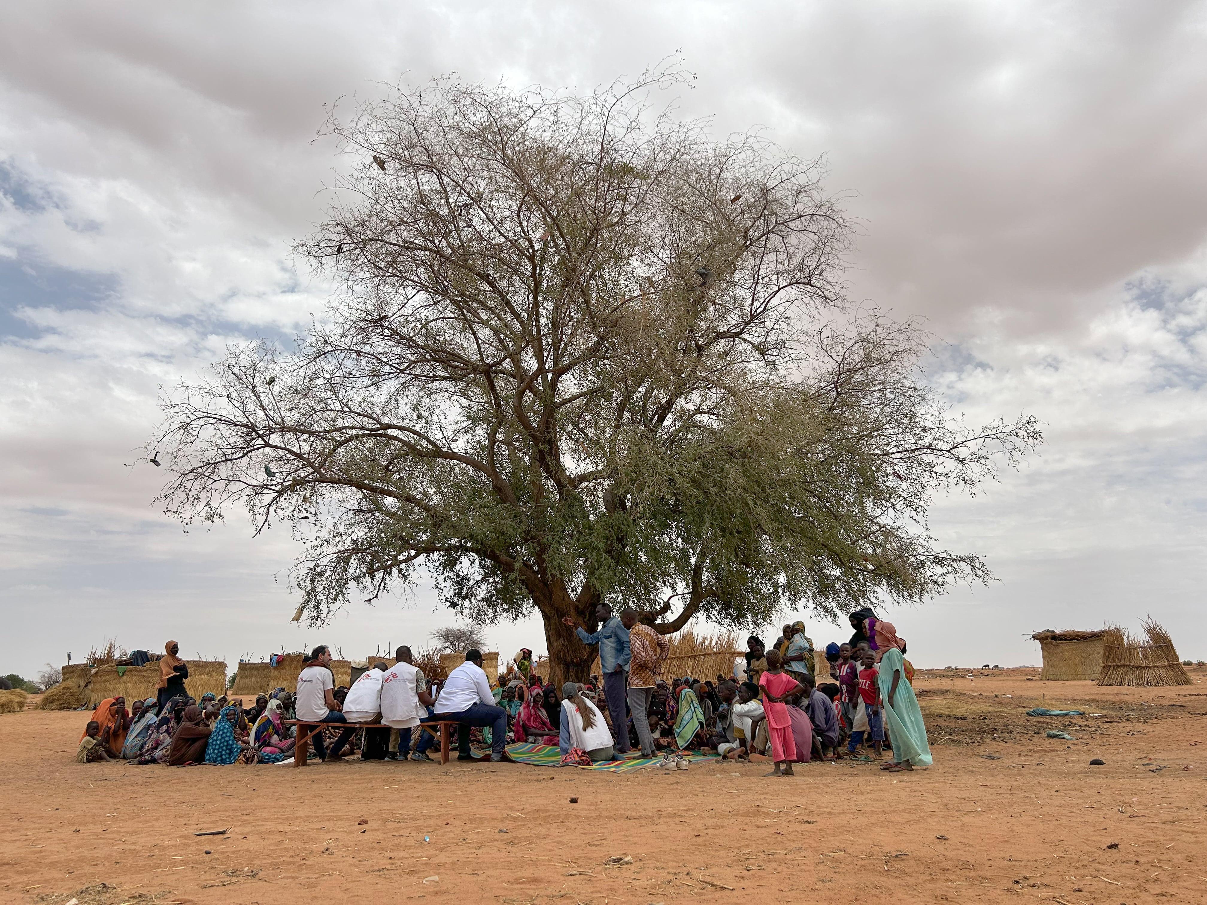 Adre, Chad: Mariam and Dr Zibert. MSF international president discussing with a refugee's community in the transit site in Adré, Eastern Chad.