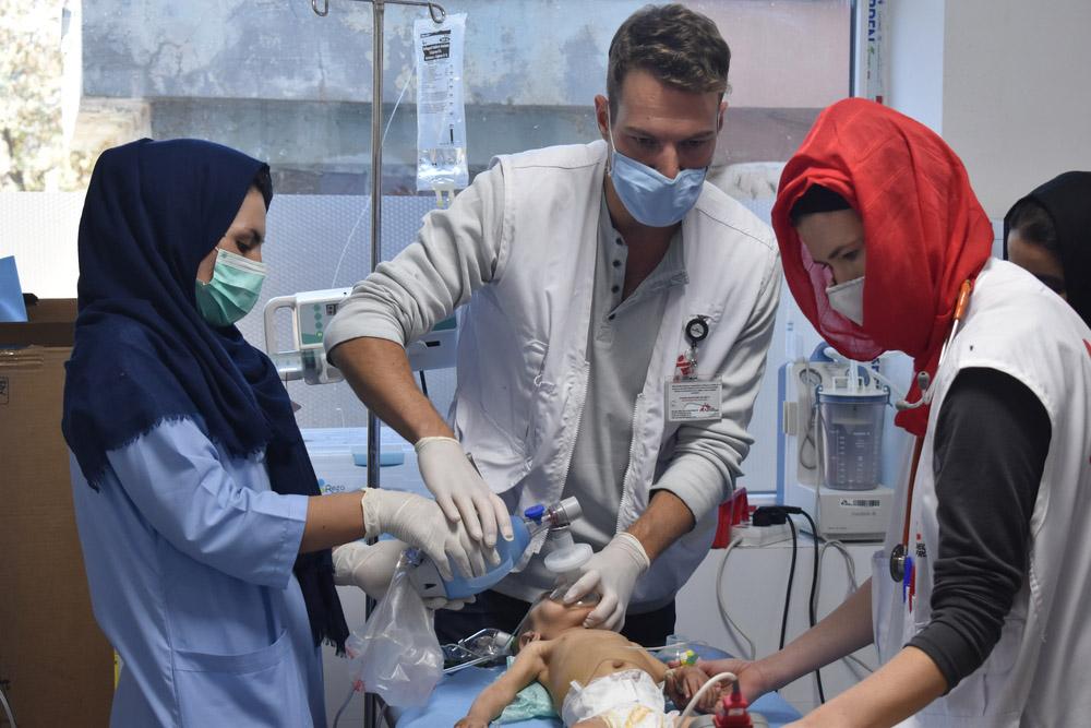 A picture of Dr. Bart Scharuwen, Nurse Marzia performing CPR procedure on a malnourished child