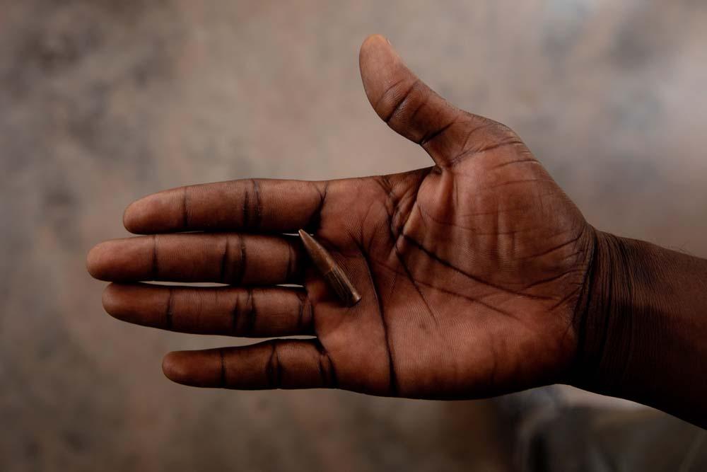 Someone shows a bullet that landed on France's property in Damala, a neighbourhood parallel to the road where the fighting happened on 13 January 2021.