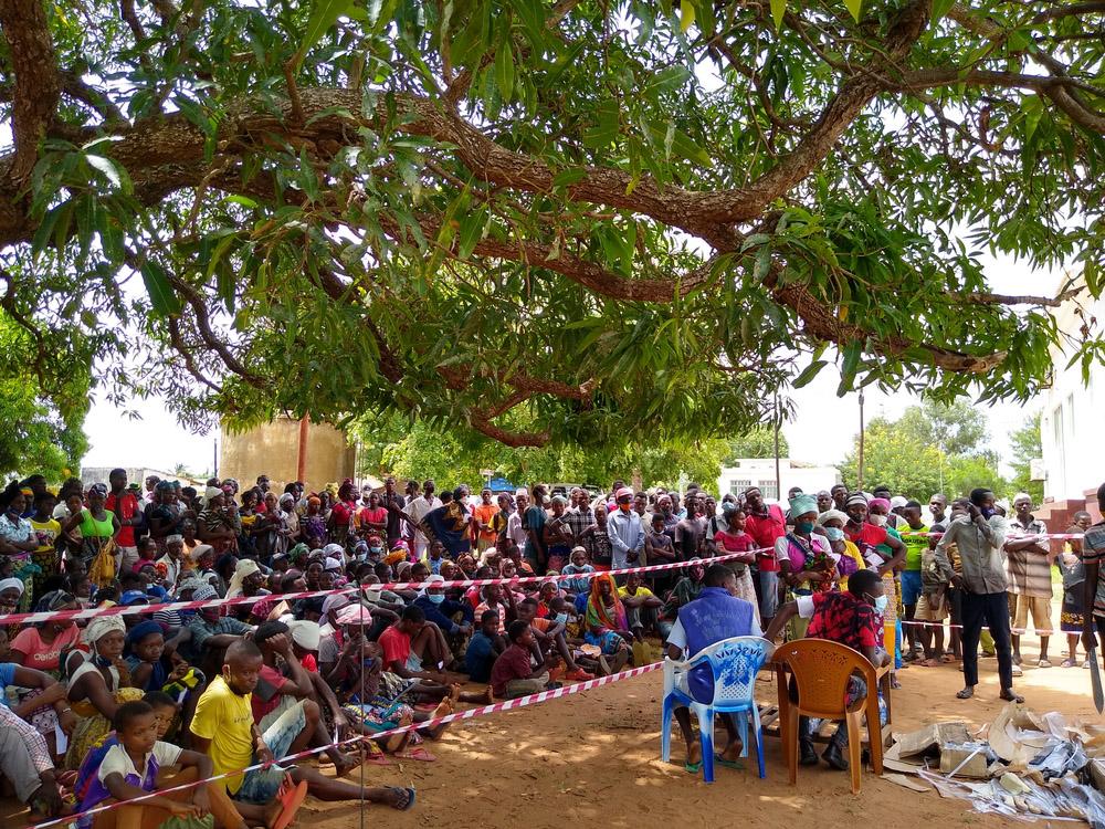 A picture of Displaced people wait for a distribution of essential relief items by MSF in Meluco,