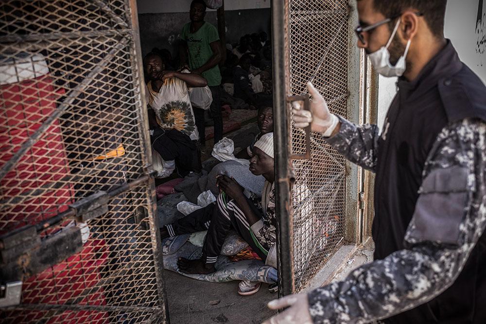 A guard is closing the door of a cell in Abu Salim detention center, in Tripoli, Libya in 2017.