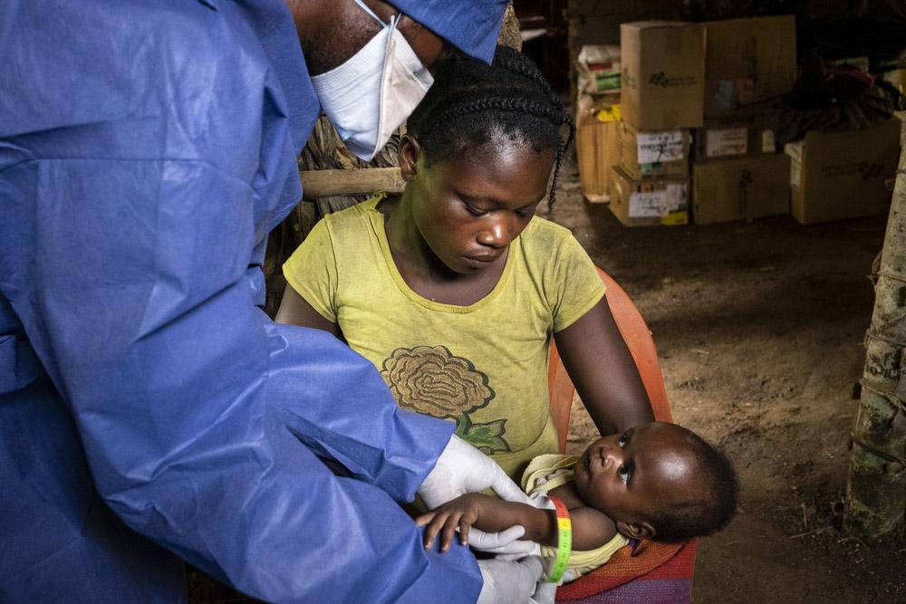 Child being measured by MSF doctor for malnutrition treatment