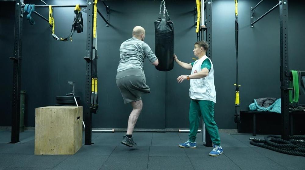 Image showing  MSF physiotherapist - Inna Didych working with war-wounded patient, Ukraine-Russia war. 