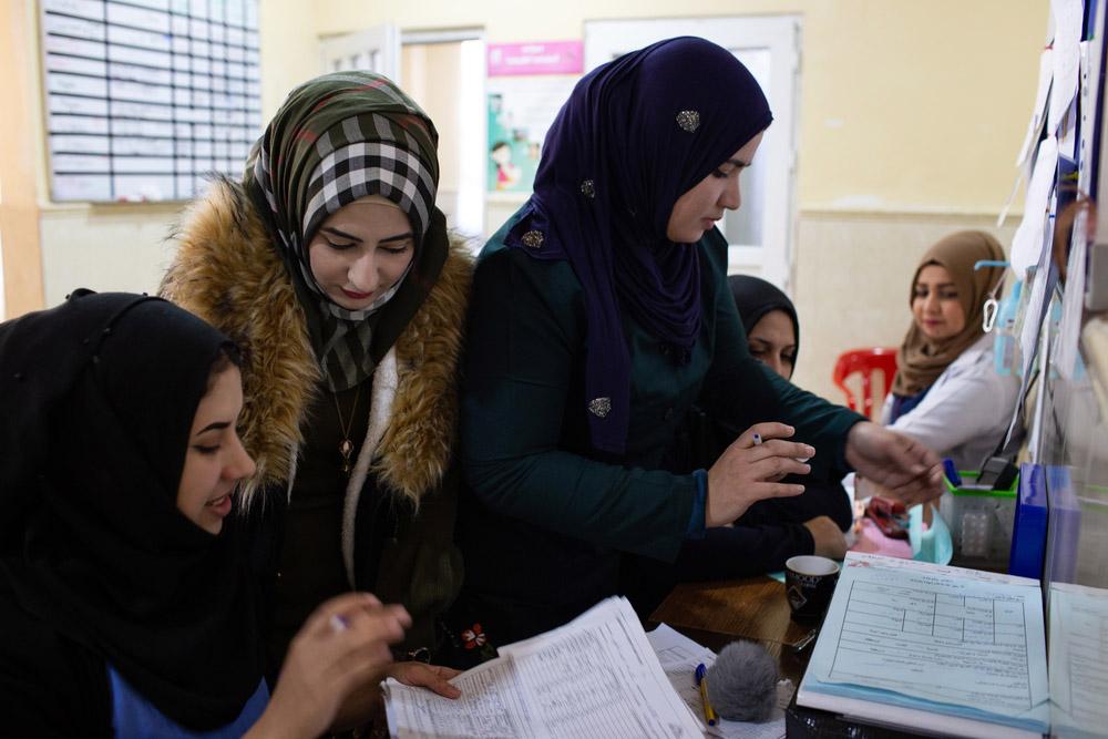 Medical data supervisor looking through files in Mosul