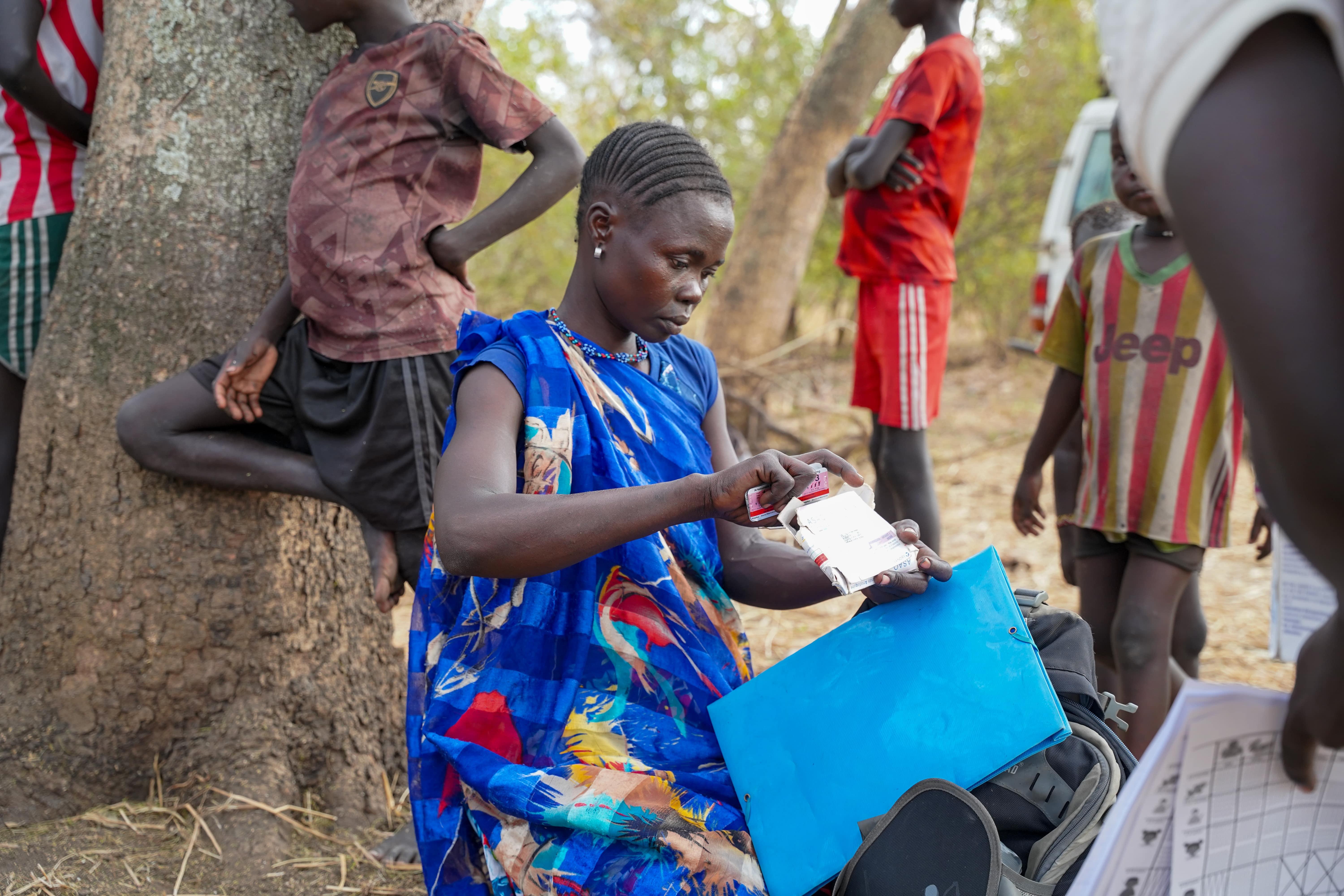 Cattle Keepers in South Sudan: Nyuruth Longony, community health worker trained by MSF, packs drug supplies during a meeting with an MSF Integrated Community Case Management (ICCM) supervisor visiting her community in Labarab, Greater Pibor Administrative Area.