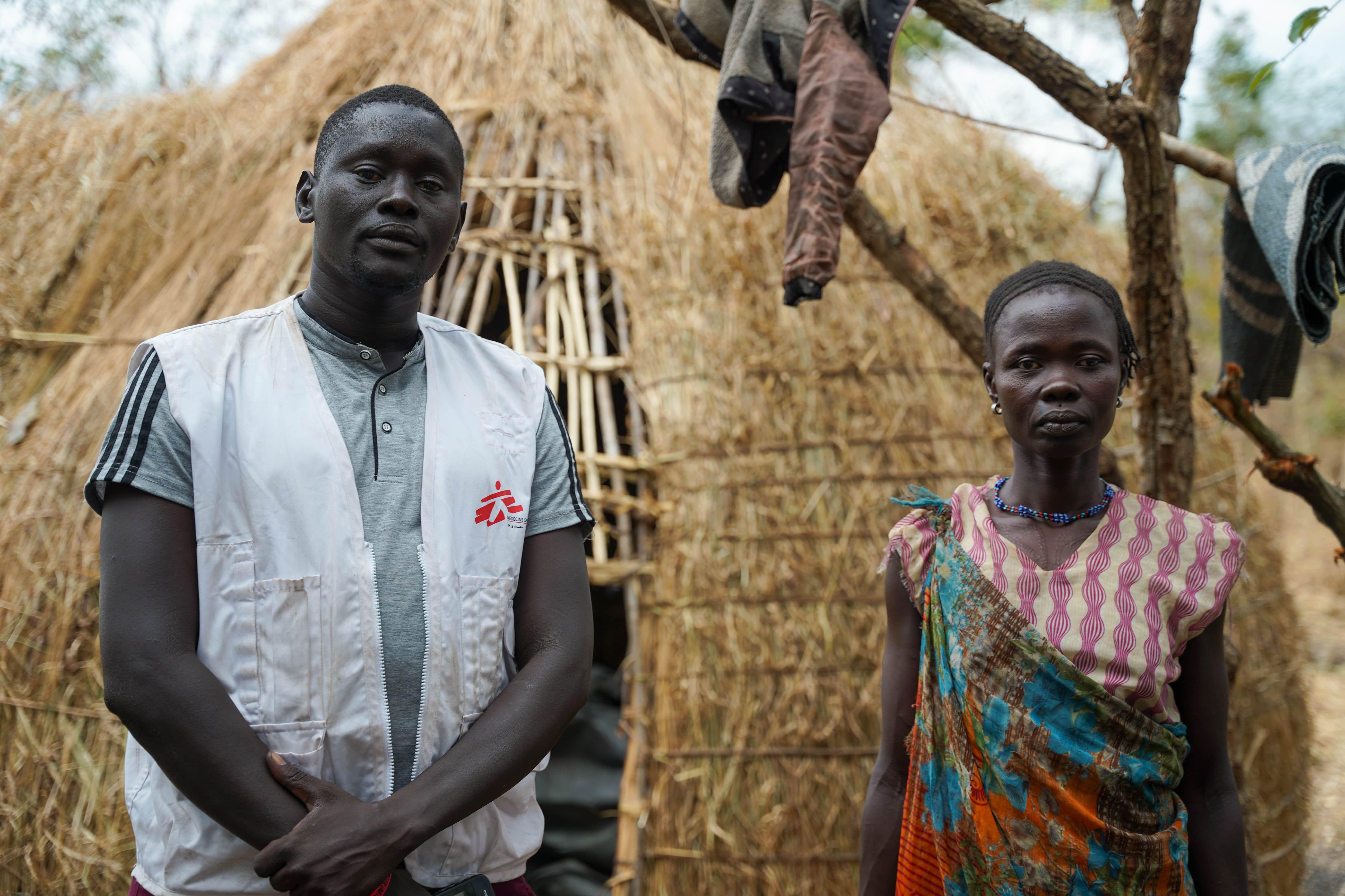 Cattle Keepers in South Sudan: Martin Kongkong, Integrated Community Case Management (ICCM) supervisor and Nyuruth Longony, community health worker stand in front of Nyuruth’s house in Labarab, Greater Pibor Administrative Area.