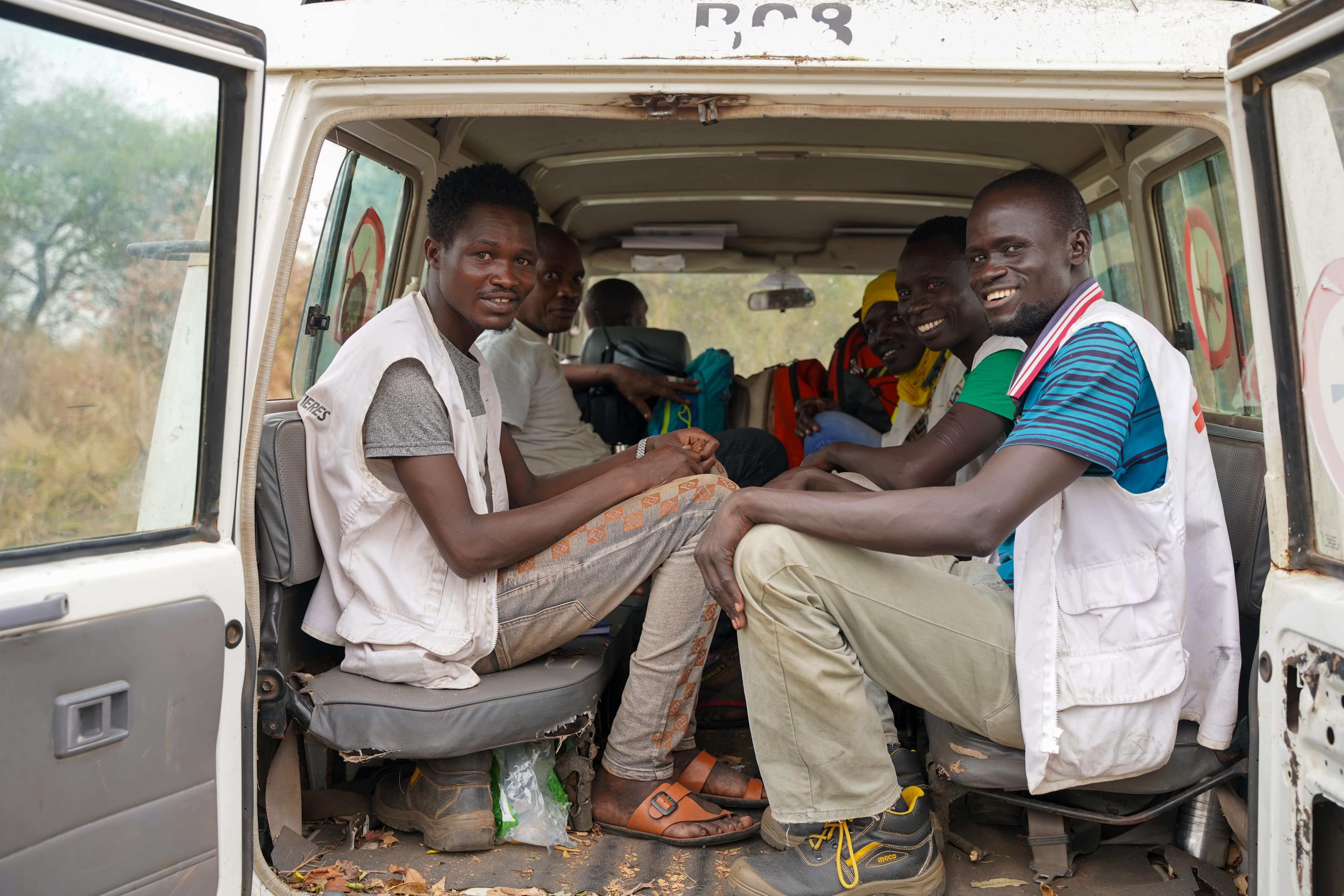 Cattle Keepers in South Sudan: MSF health promotion and WATSAN teams sit at the back of an MSF car during a four-day outreach visit among cattle keepers communities in Labarab, Greater Pibor Administrative Area.