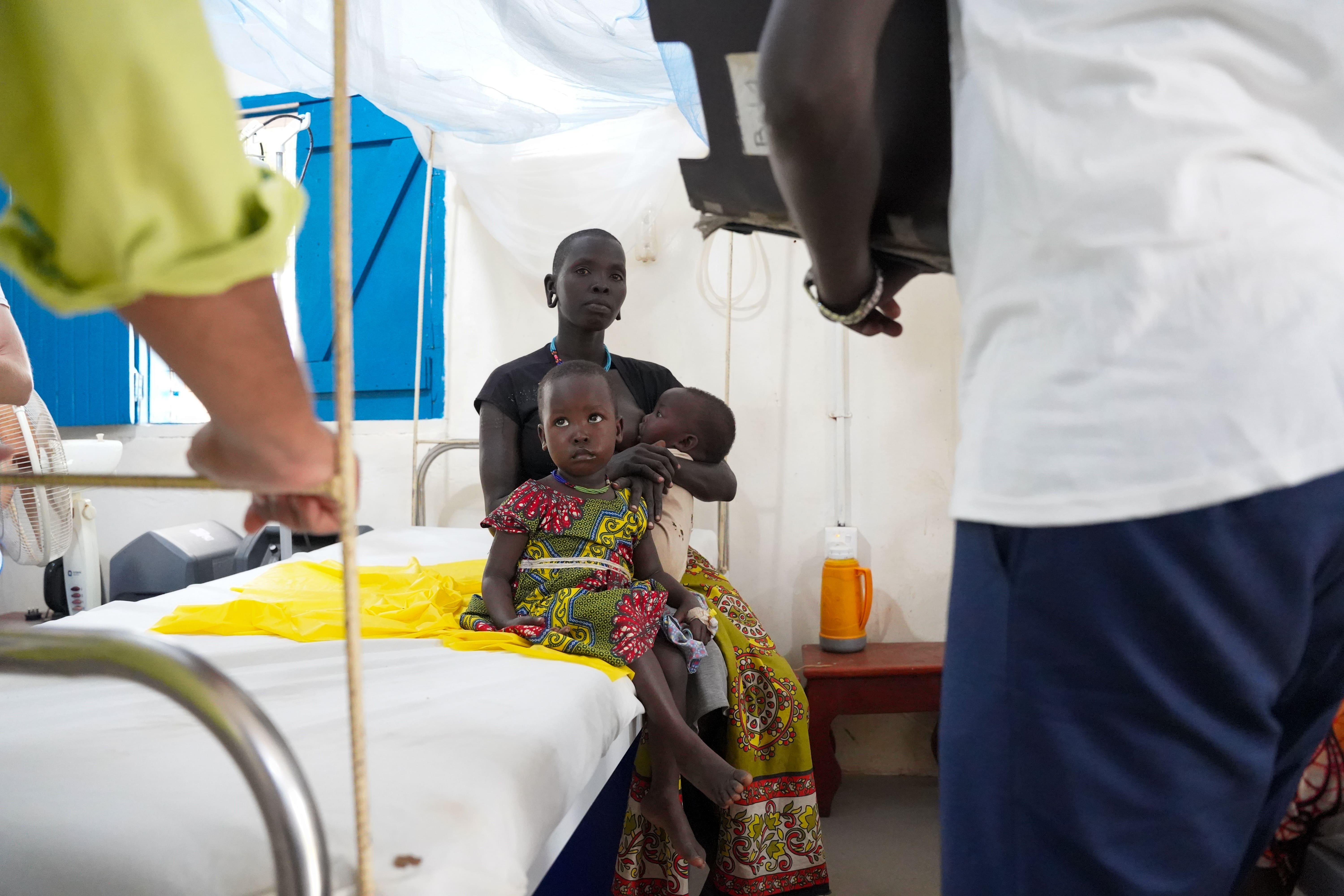 Cattle Keepers in South Sudan: Ngalo Barkuni sits next to her 4-year-old daughter, Milleng Alfred while she is being treated at the MSF-supported inpatient ward for children under 5 years, in Boma primary healthcare centre, Greater Pibor Administrative Area.