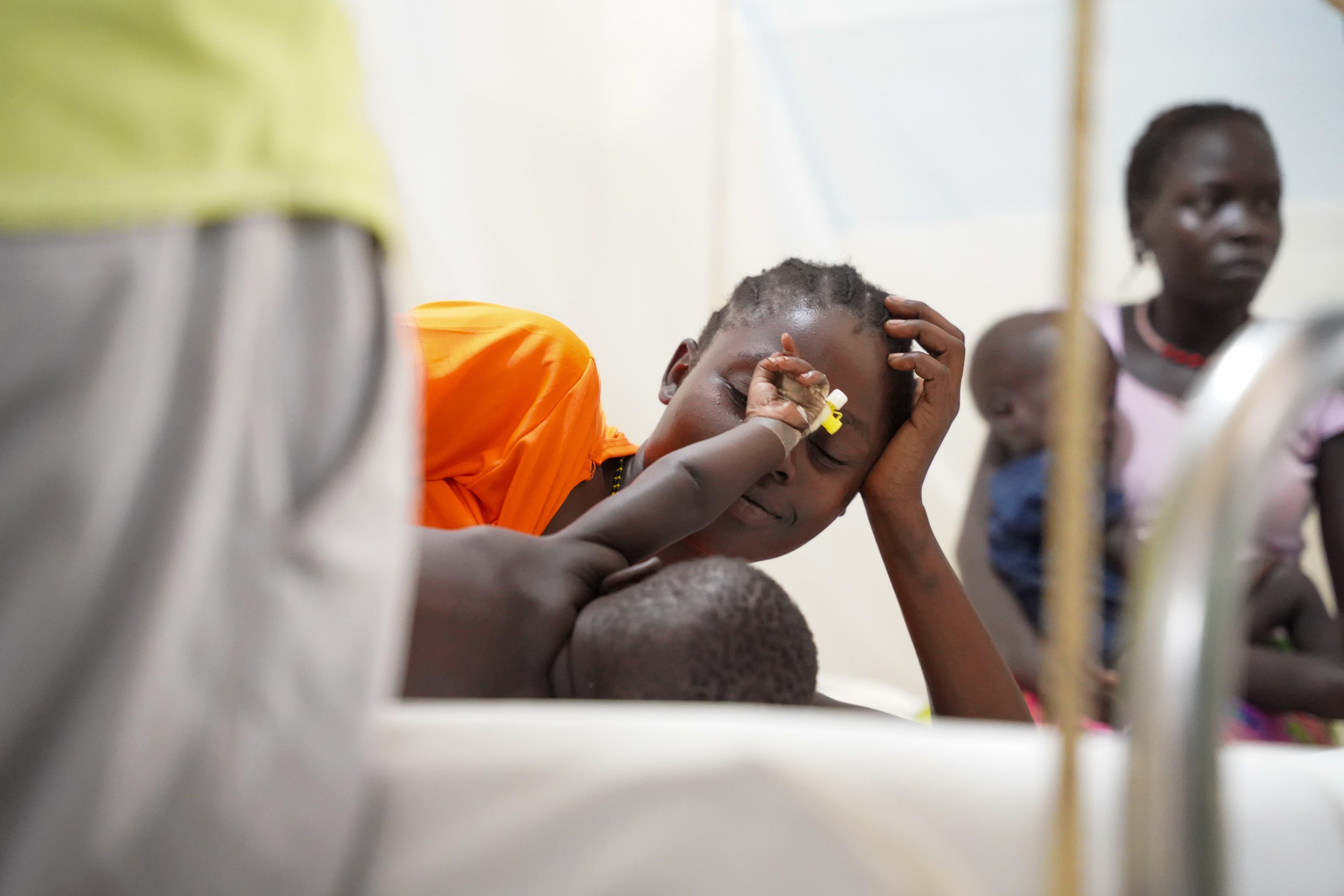 Cattle Keepers in South Sudan: Agut Nyilim plays with her 9-month-old baby boy while he is treated at the MSF-supported inpatient ward for children under 5 years, in Boma primary healthcare centre, Greater Pibor Administrative Area.