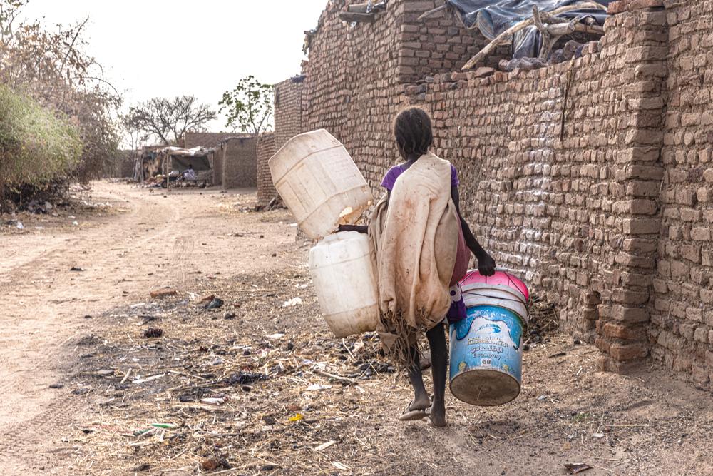 Child carrying jerry cans to collect water in Al-Hasahisa camp, Zalingei, Central Darfur state, Sudan.