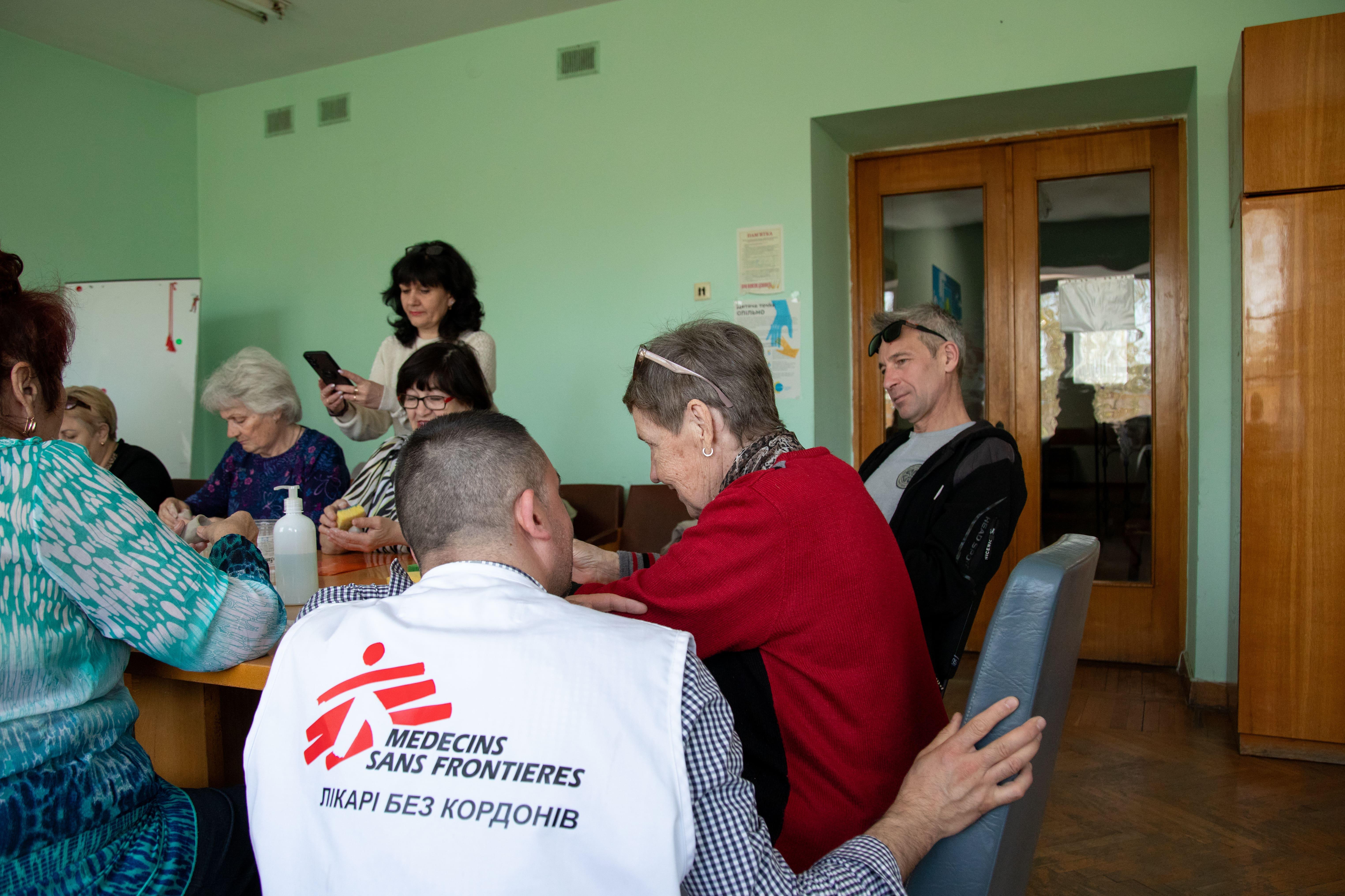 Psychological Support in Ukraine: During a health promotion session, Oleh Pohrebniak, MSF health promoter, talks to Lidia Bazualyeva, an MSF discharged patient who had celebrated her 74th birthday the day before.