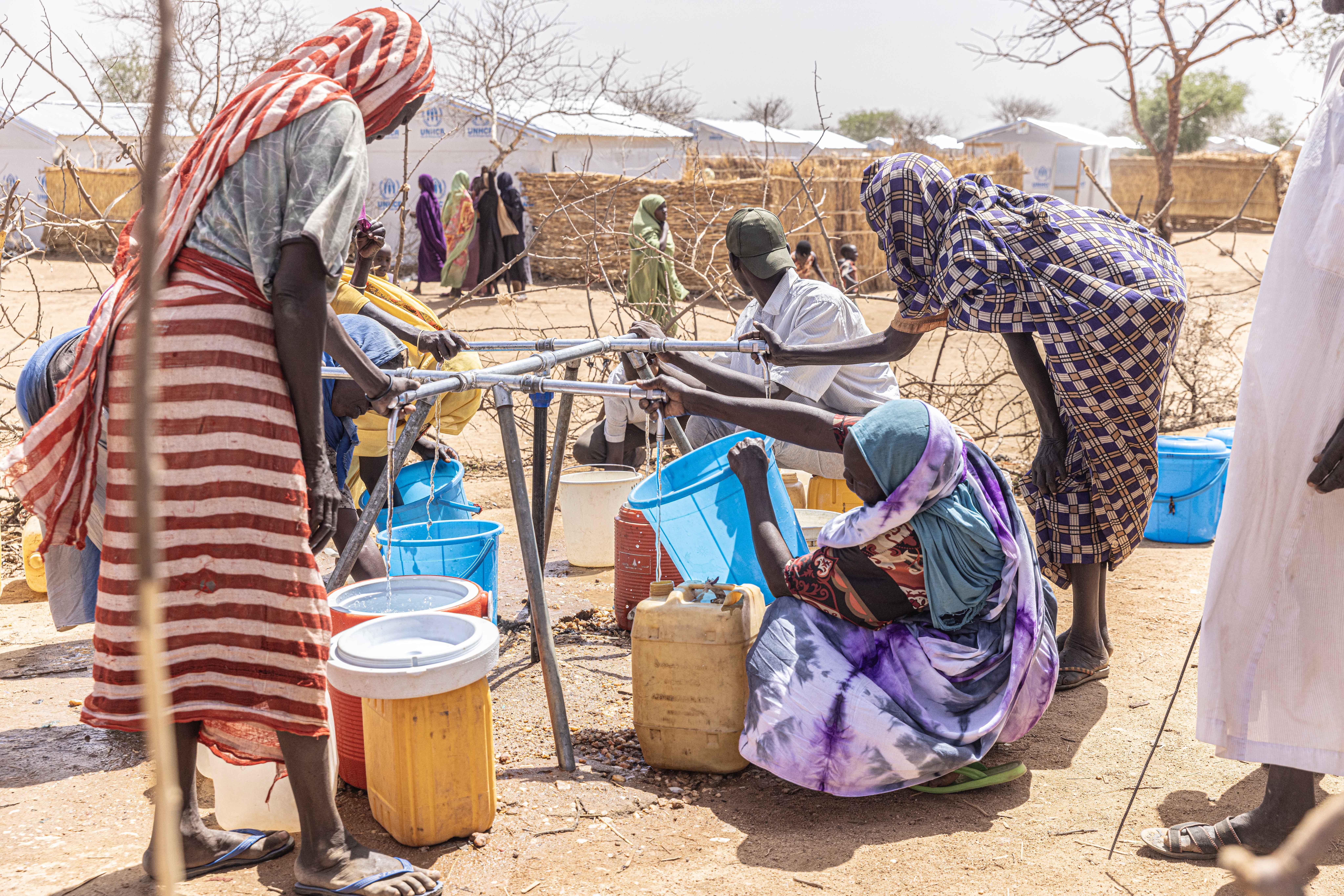 Eastern Chad: Supply Distribution  Women collecting water at a distribution point in Alacha camp, eastern Chad.