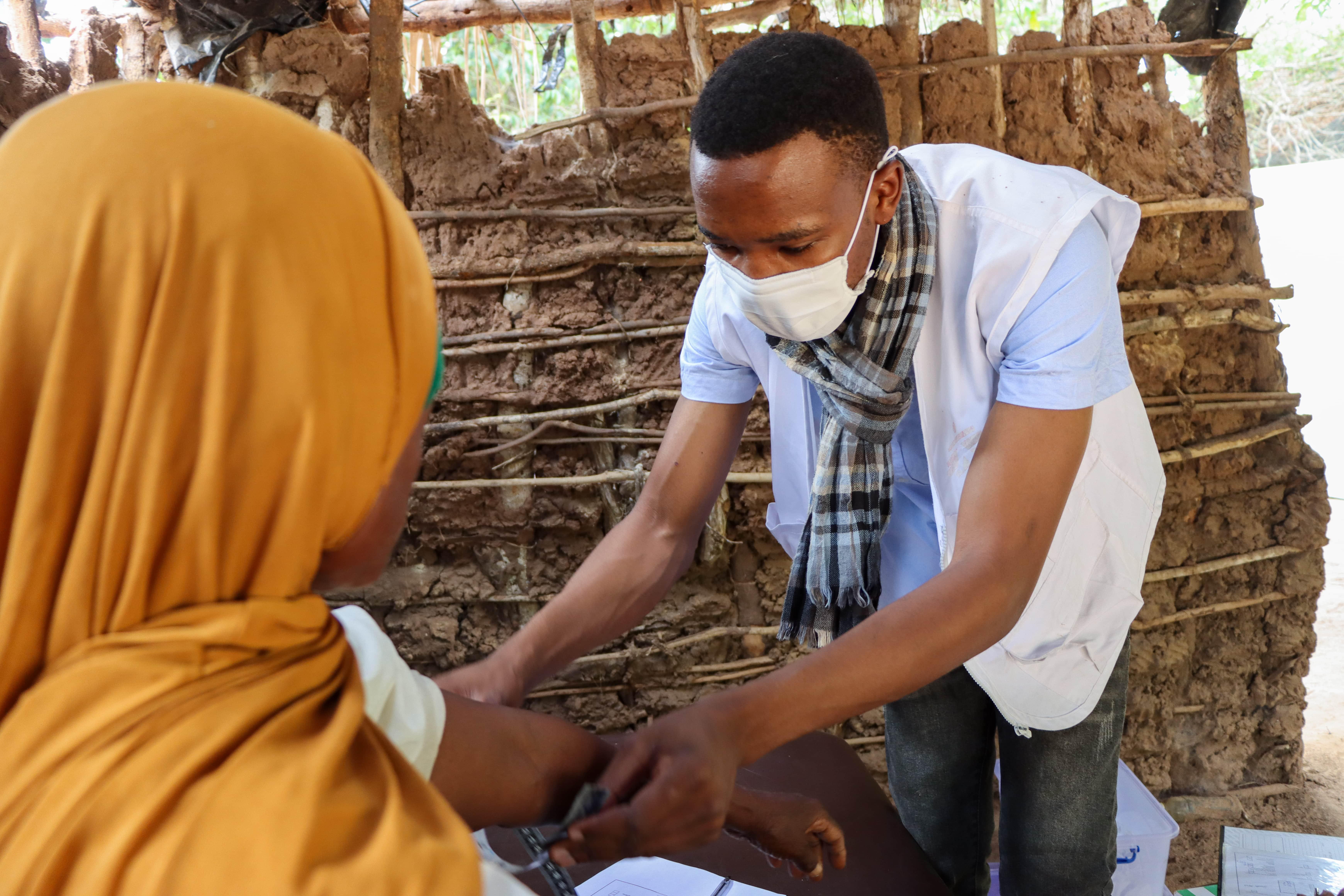 Face Masks Mozambique : A nurse wears a reusable face mask during a patient consultation in northern Mozambique, where climate-sensitive diseases, such as those spread by mosquitoes, are common.