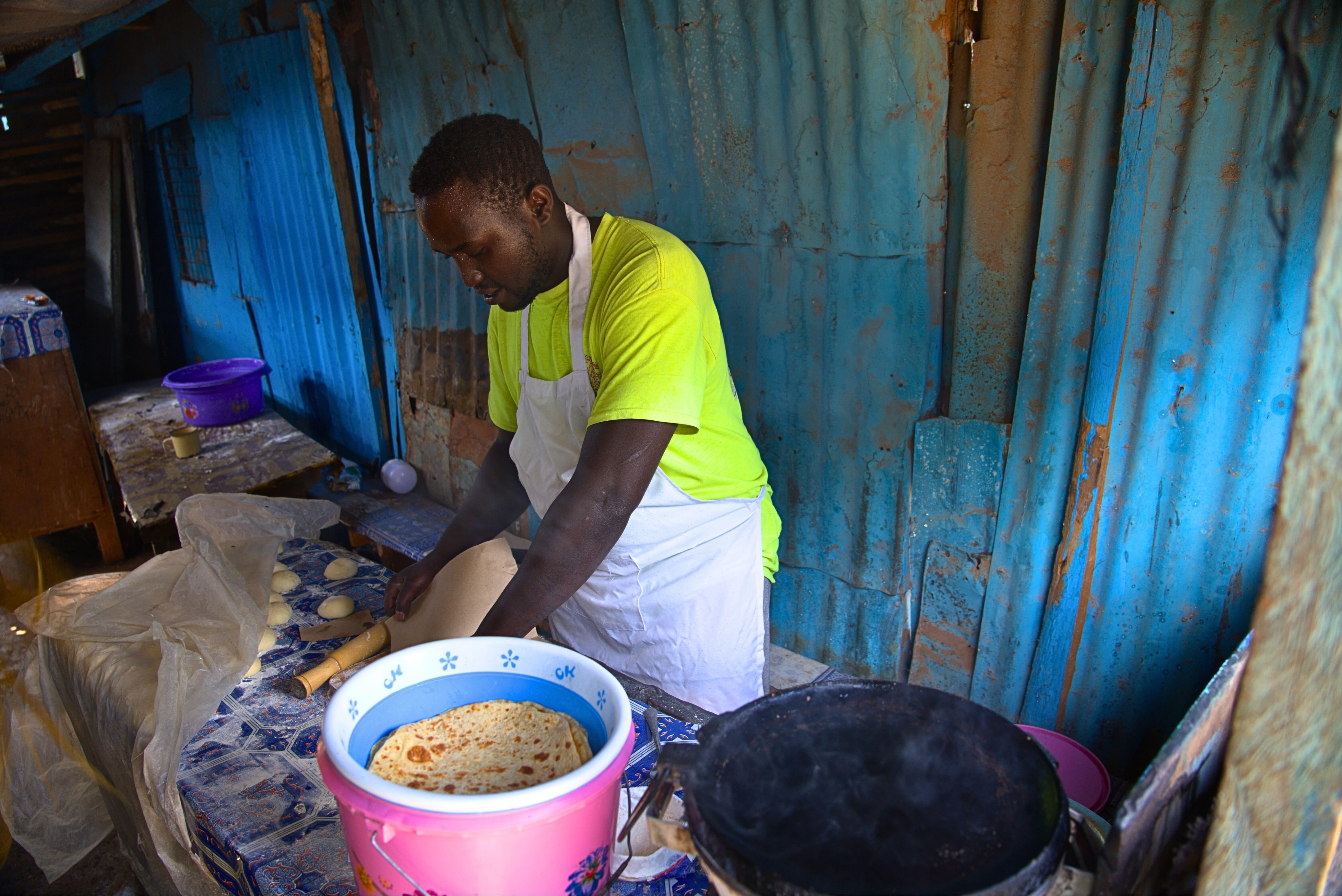 Treatment of People Who Use Drugs in Kenya: Michael Karongo at his food kiosk where he sells chapatis. Michael has been in recovery for 5 years and is reintegrated into the society, and now owns his business and goes to school too.