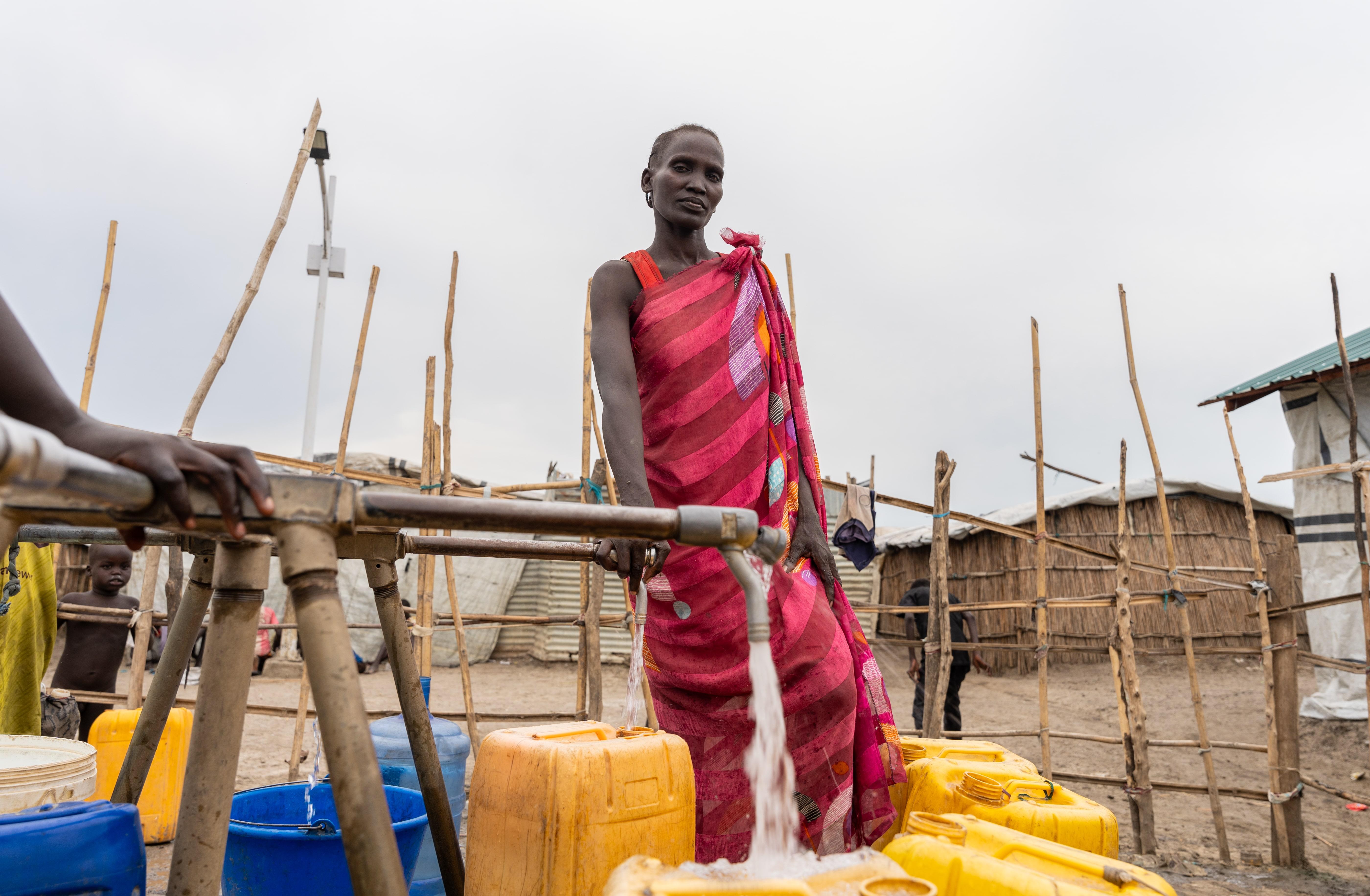 Life-saving care in Sudan: Nyachany Biliew, 30-year-old, is fetching water from a well located 7 minutes' walk from her shelter. The mother fetches 40 litres a day so that her family of seven can cook, drink, and shower.