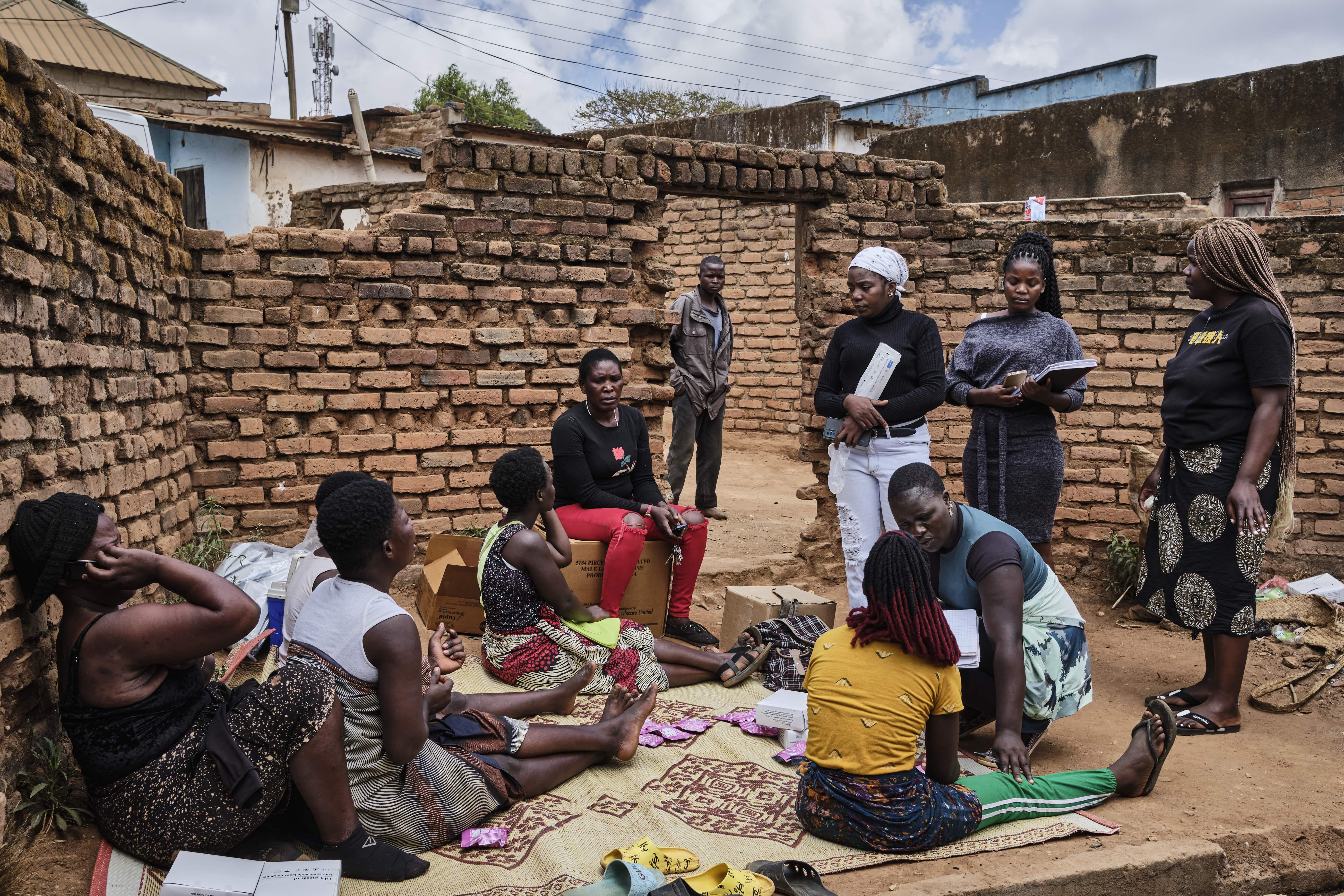 Sex Workers in Malawi: Memory Saweruzika records information from a sex worker in Dedza. MSF works with peer sex workers as Memory, a group of sex workers who have organized themselves into Community Based Organizations (CBO) to defend their sexual and reproductive rights.