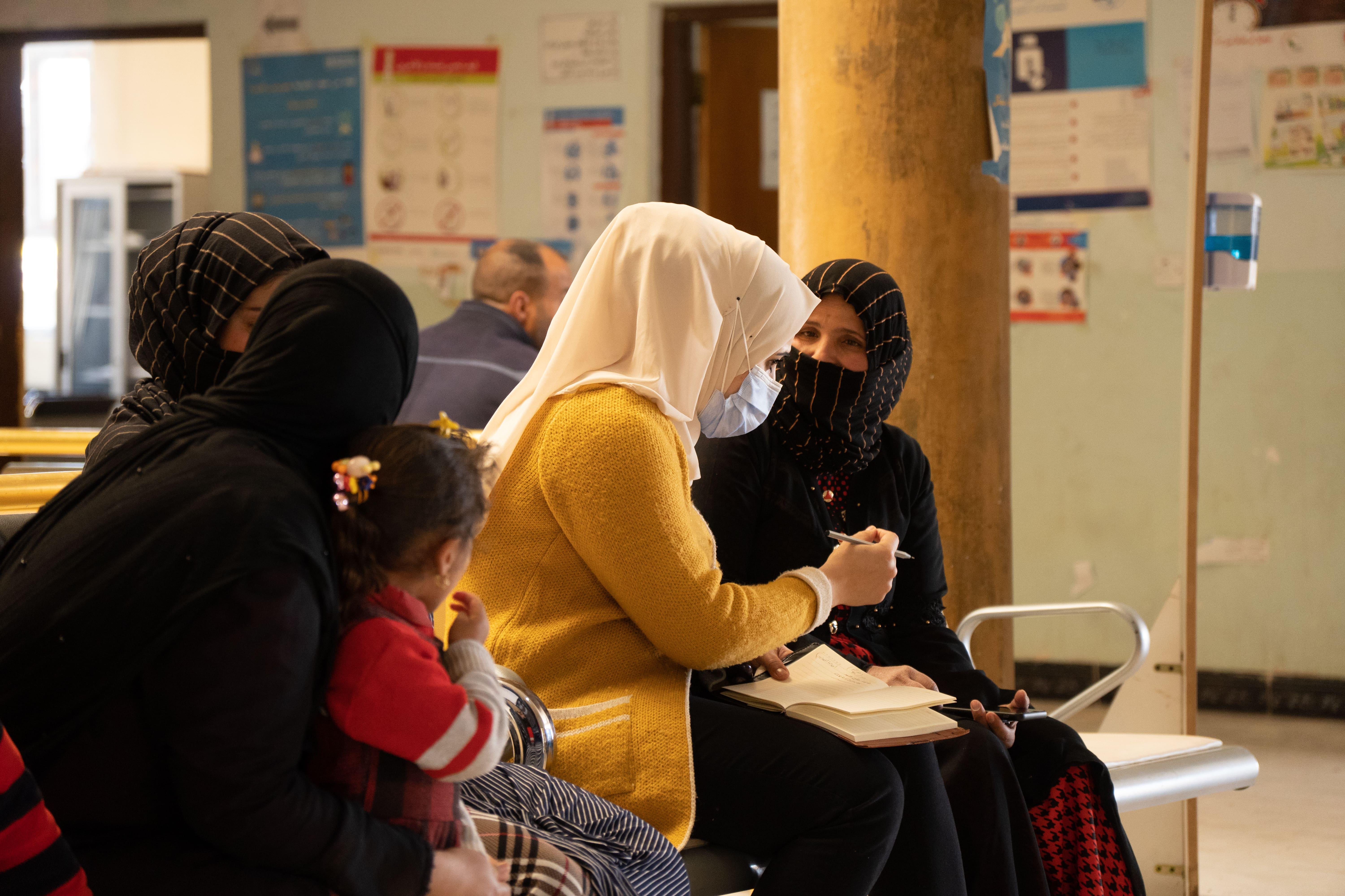 Medical Care in Iraq: An MSF community mental health worker conducting a health promotion session with a group of women and their children in Hawija
