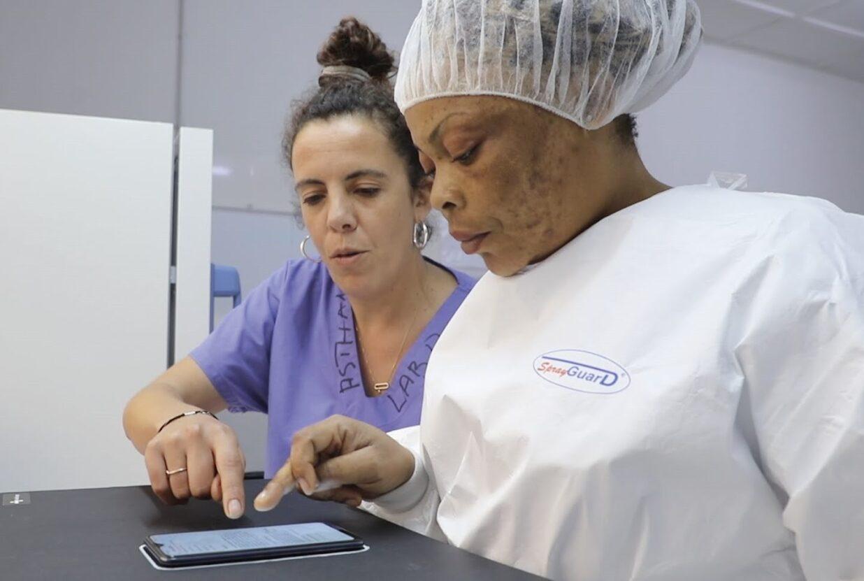 Dr Nada Malou teaching a lab technician how to use Antibiogo, an app that help prevent antibiotic resistant bacteria in low-income countries. 