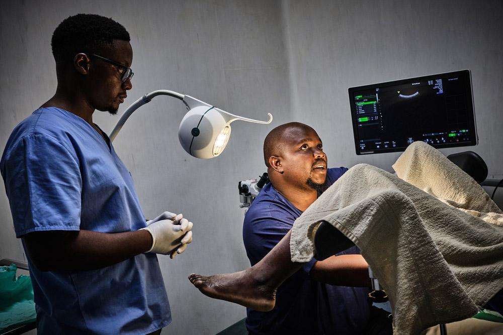 Gynaecologist George Chilinda performs a biopsy on a patient 