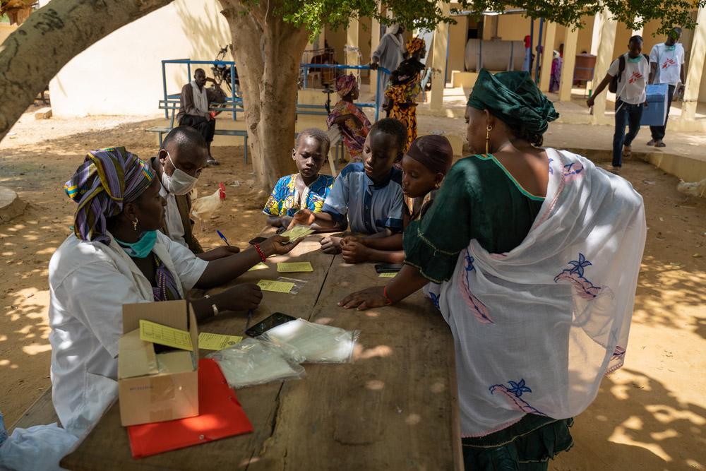 Parent waiting with her child to get vaccinated against measles