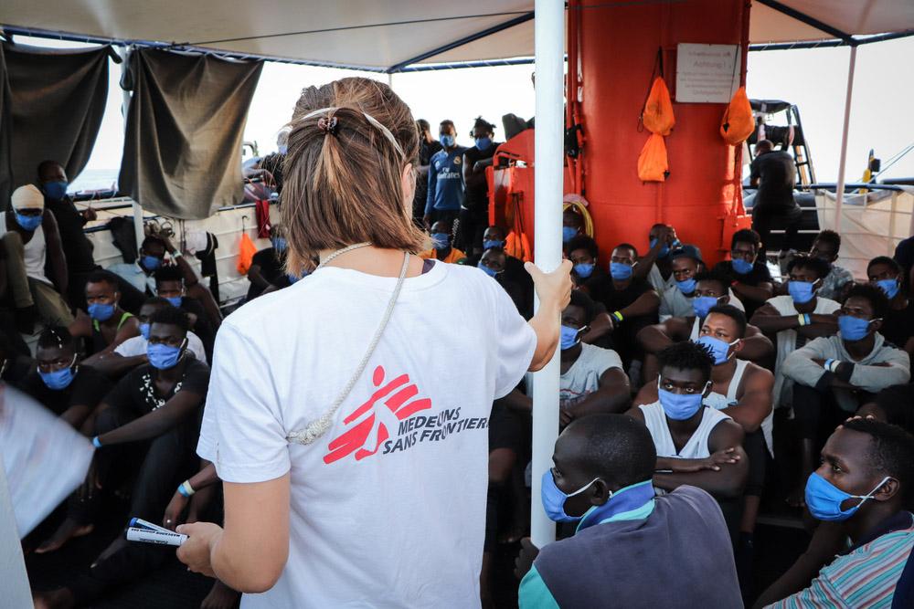 MSF Doctor  Aniek briefs rescued people on board Sea-Watch 4 regarding COVID-19 protocols