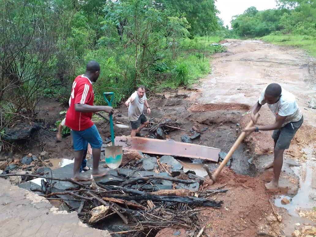 Picture of people building a makeshift bridge to try and cross the river